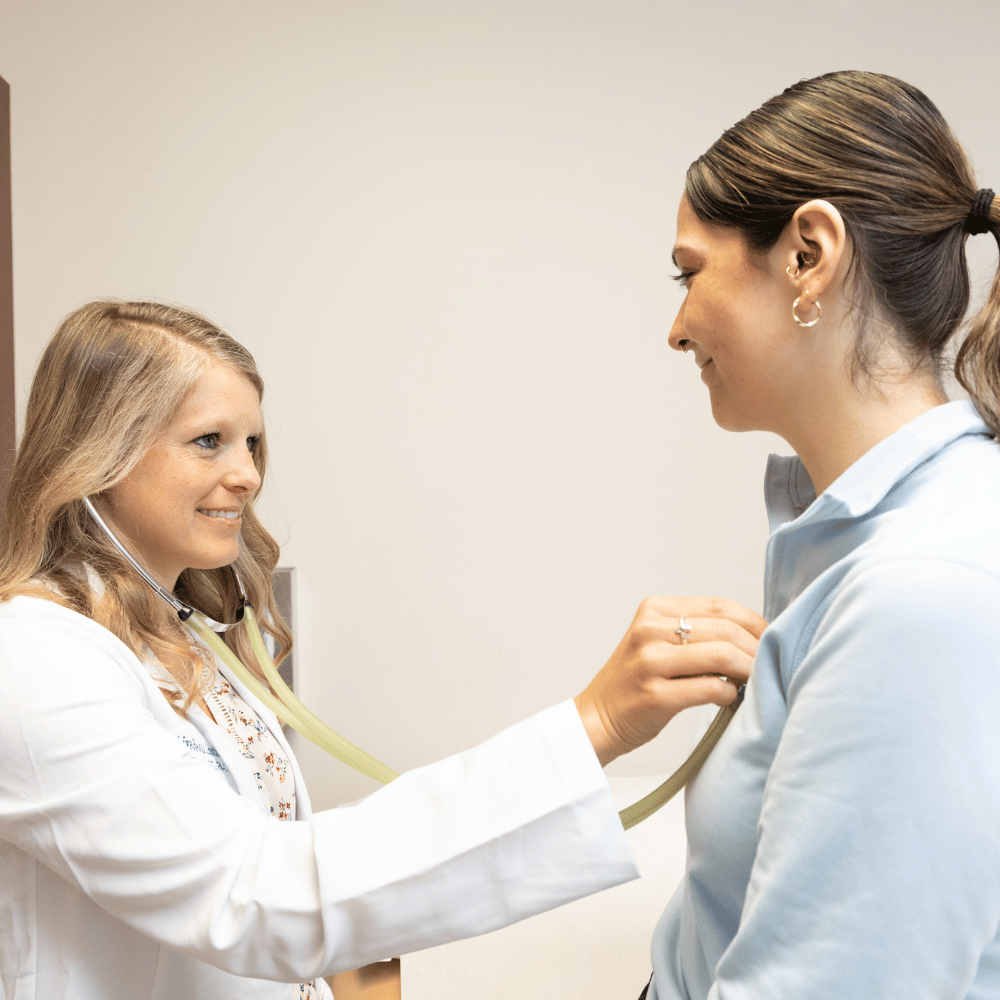 About the Digestive health Institute Andrea Koerner using a stethoscope to check a patient