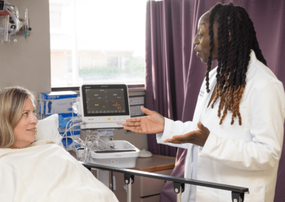 Dr. Lee Allen with Patient by bedside of Surgery Center